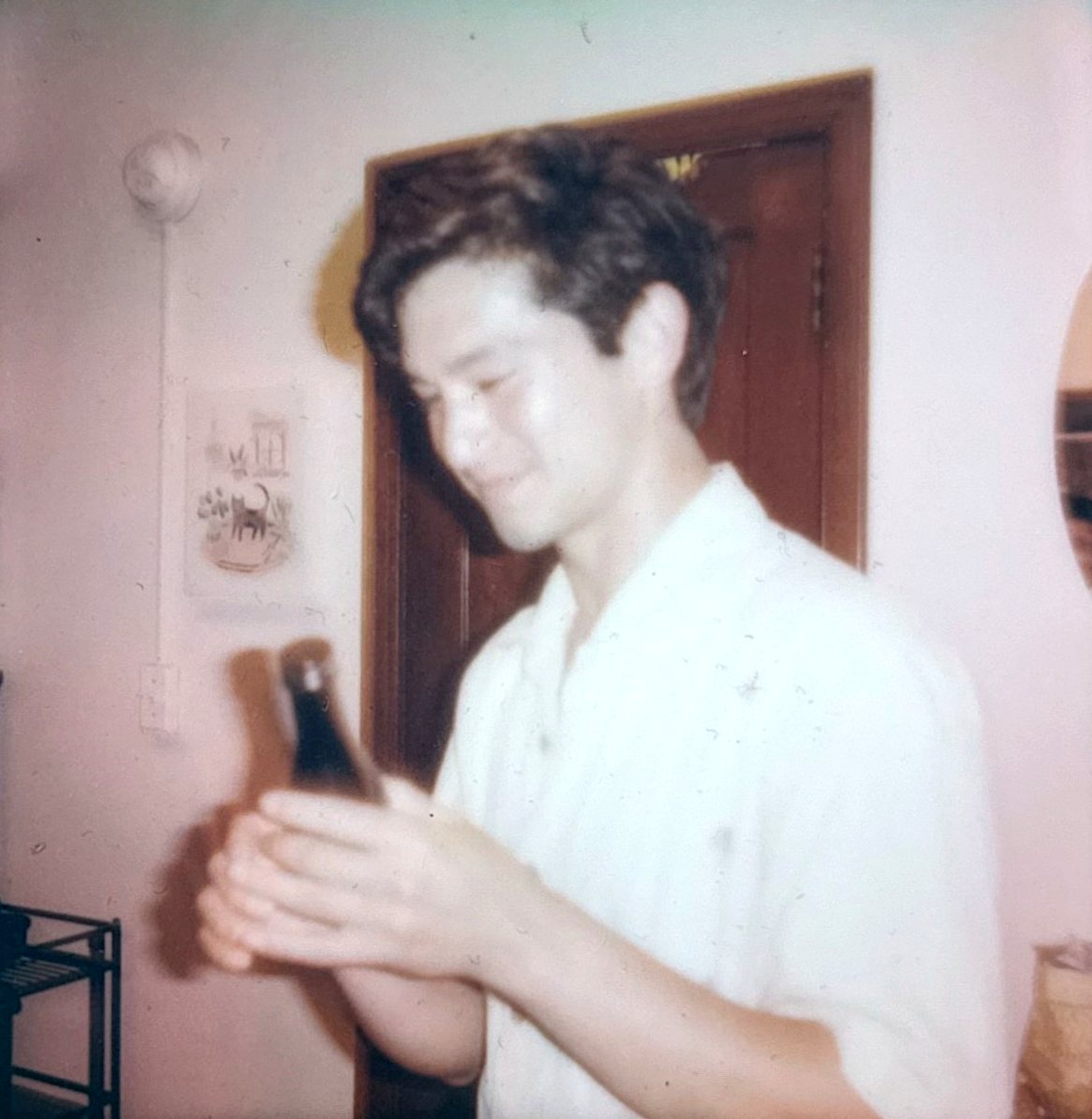 A member checking a sake bottle during the June tasting